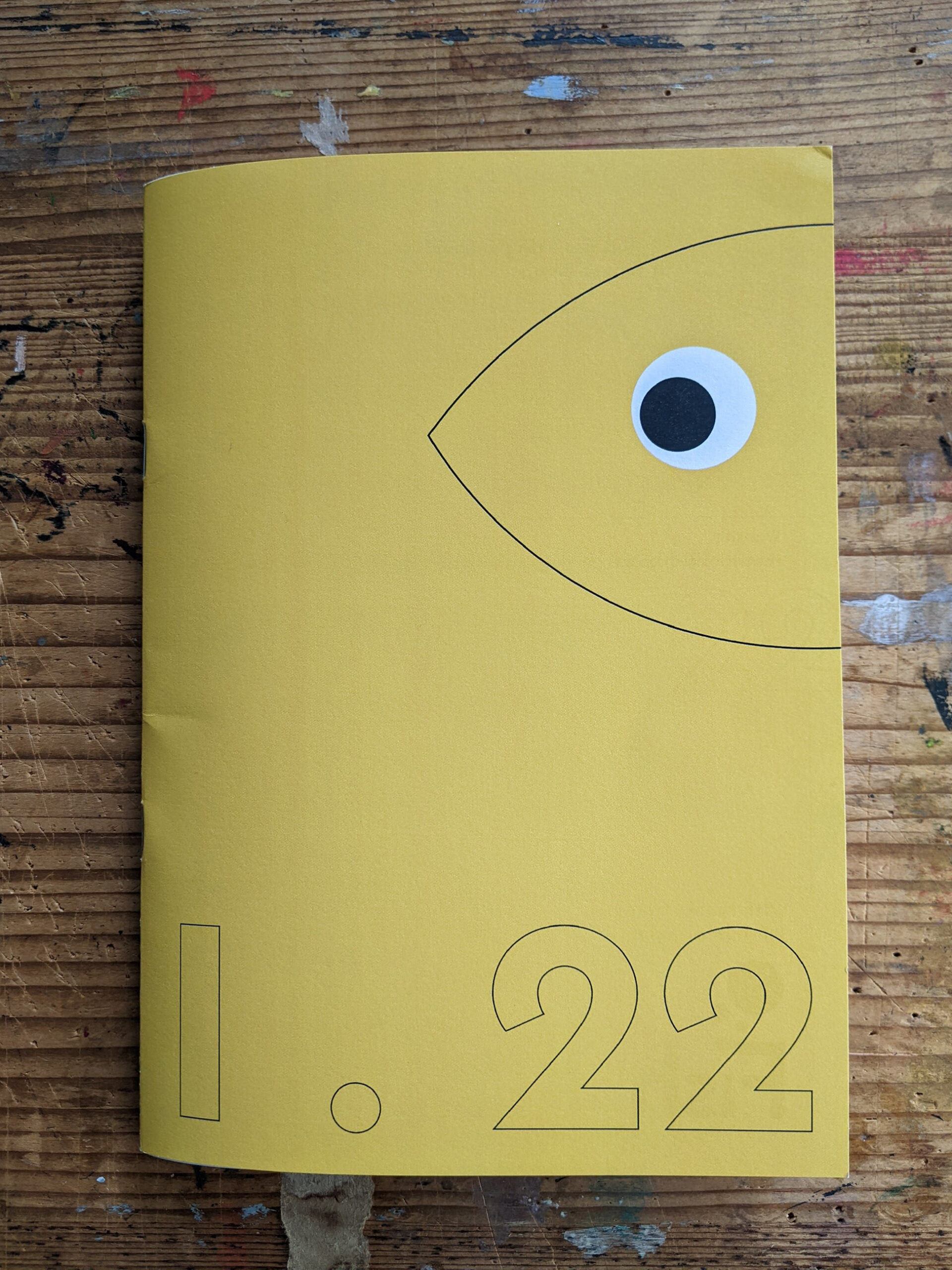 An Image of a yellow booklet with a picture of fish and the numbers 1 and 22